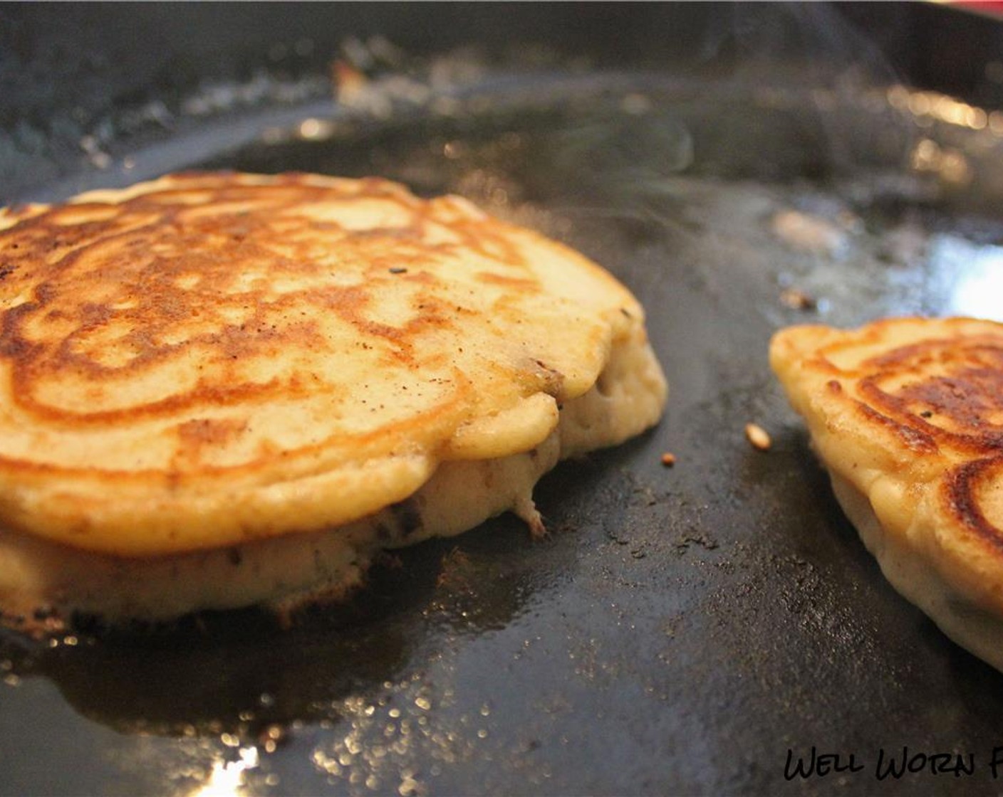 step 6 Once bubbles form in the batter around the outer edges, use a spatula to check the bottom of the pancakes for color. If they look good, flip and cook through on the other side. Transfer cooked pancakes to a plate.