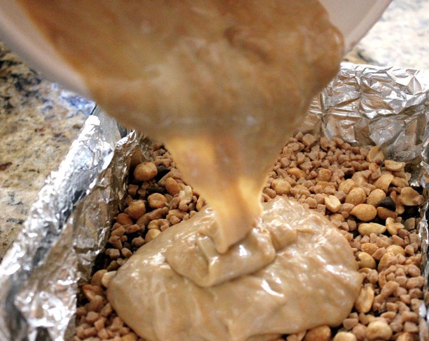 step 4 Evenly sprinkle the Milk Chocolate Chips (1 cup), Toffee Bits (1 cup), and Peanuts (1 cup) on top of the graham crackers. Then pour the peanut butter mixture on top.