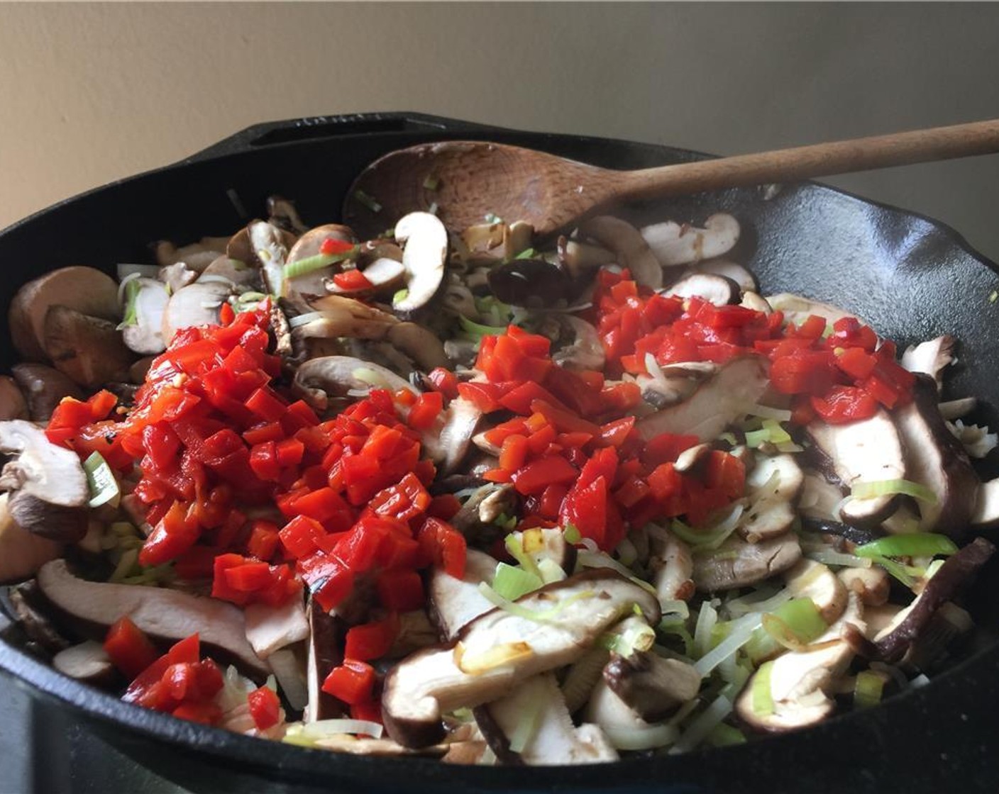 step 10 Add mushrooms and peppers and sauté for 5 minutes.