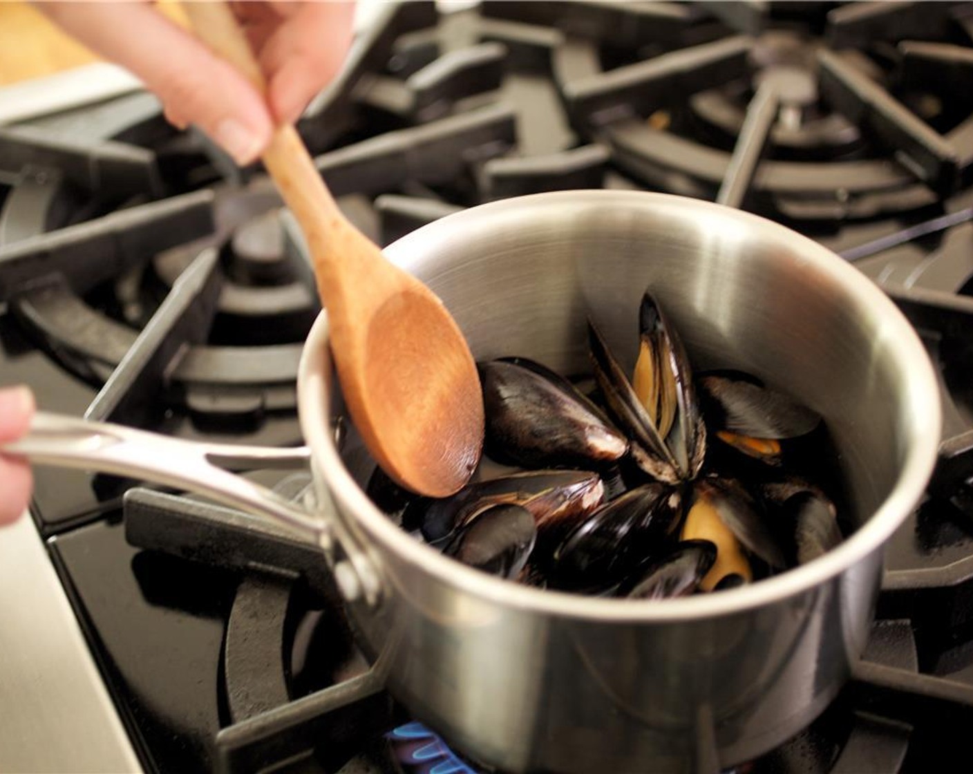 step 10 Carefully add mussels, being sure not to break the shells. Cover and simmer until mussels open and are just heated through, about two minutes.