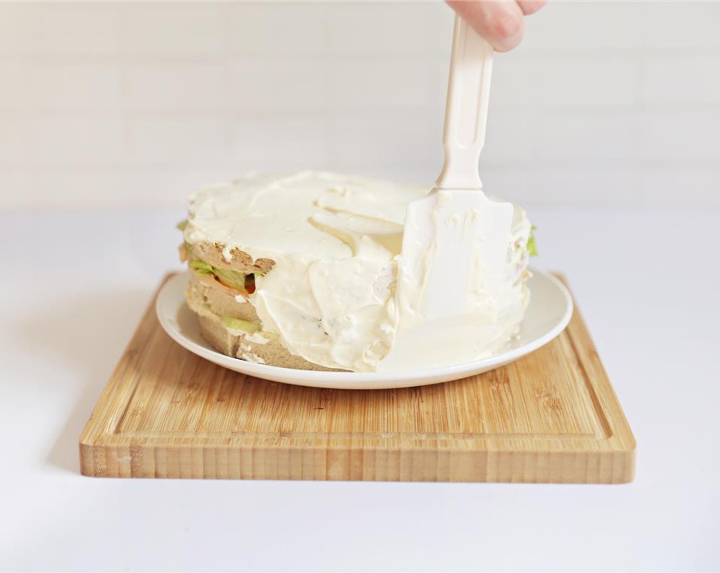 step 9 Use spatula to spread icing on the side of the cake.