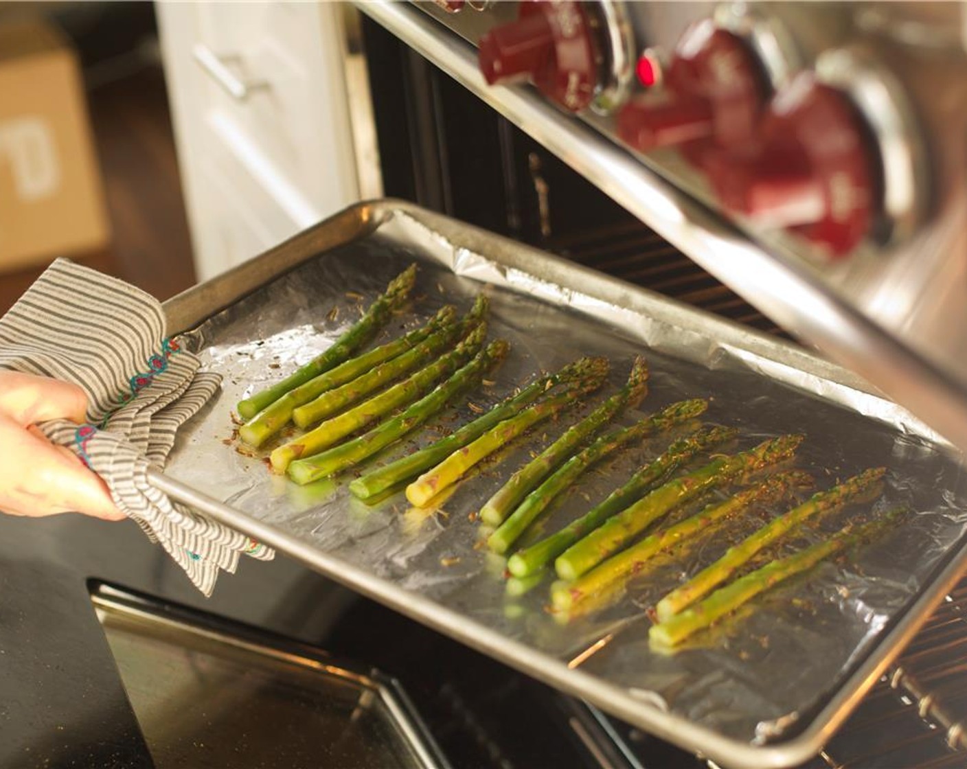 step 10 Lay the asparagus onto the sheet pan and drizzle with Olive Oil (1/2 Tbsp). Sprinkle with the Herbes de Provence (1/2 tsp) and place in the oven for ten minutes. Remove from oven and keep warm.