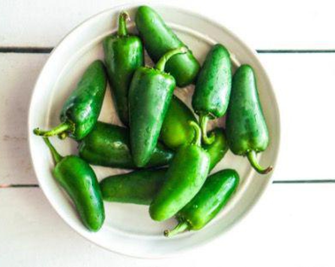 step 2 First, prep the Jalapeño Peppers (5 cups). Slice them in half lengthwise, then remove the seeds and ribs using a spoon or paring knife. Rinse and pat dry, then line on a baking sheet that has been drizzled with Olive Oil (as needed). Toss the peppers to coat in the oil and set aside until needed.