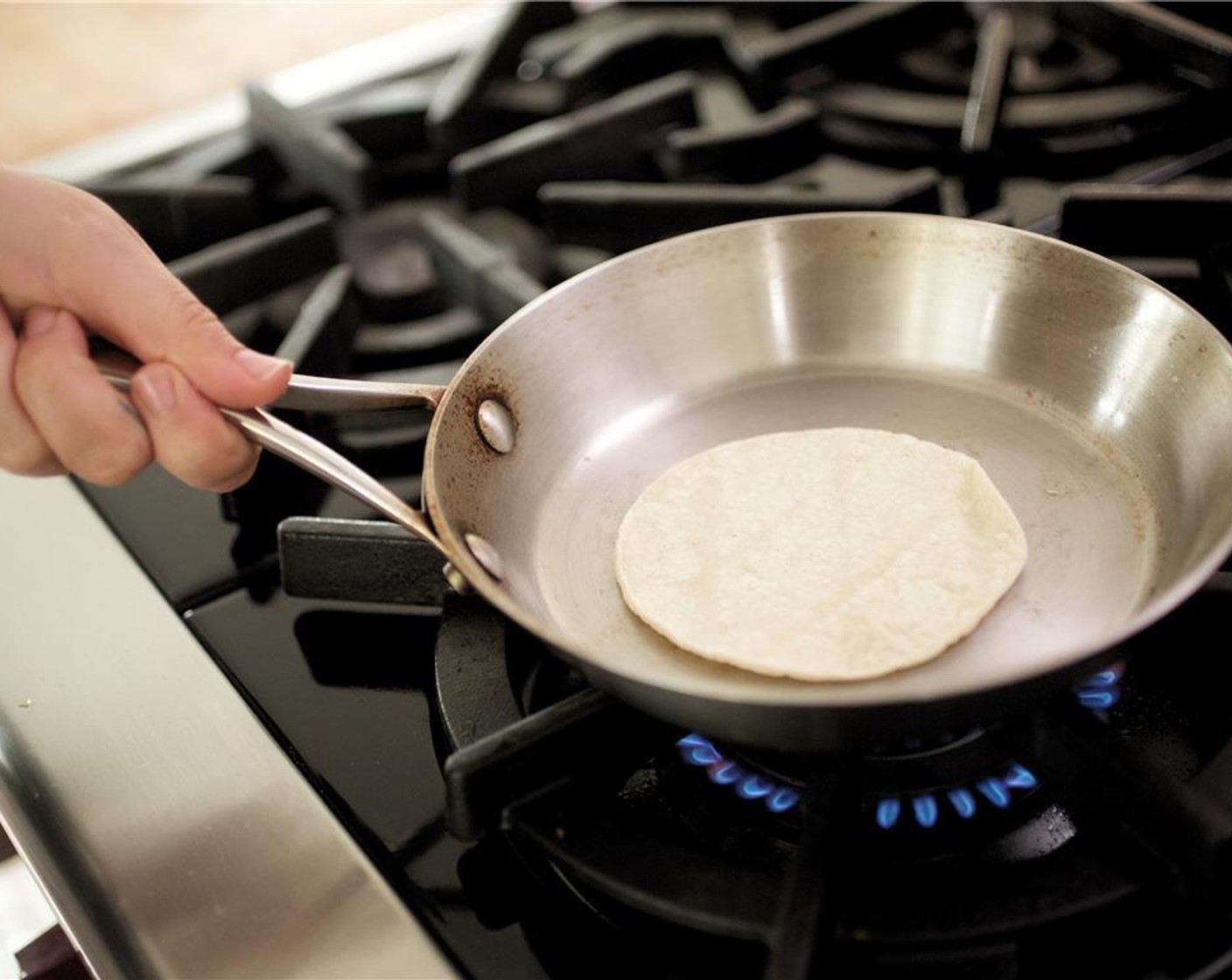 step 16 Heat a small saute pan over high heat, and once hot, add White Corn Tortillas (4) one at a time. Cook each side for thirty seconds until very hot.