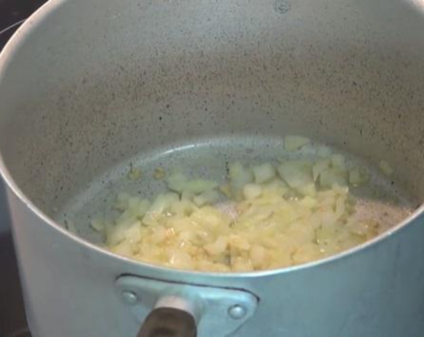 step 1 Inside a pot under medium heat, add the Olive Oil (as needed), Garlic (2 cloves), and Yellow Onion (1). Stir through for a while until the onions are softened.