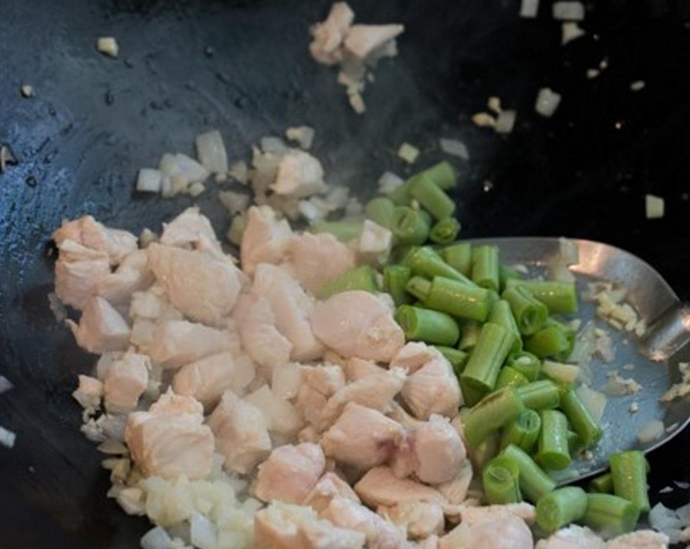 step 7 When the onions start to turn translucent, toss in the Green Beans (1/4 cup) and give it a good stir.