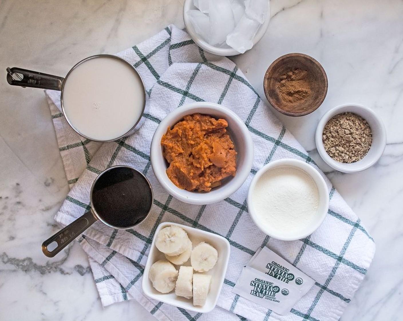 step 1 Add Unsweetened Vanilla Almond Milk (3/4 cup), Banana (1), 100% Pumpkin Purée (1/3 cup), Coffee (1/4 cup), Protein Powder (2 Tbsp), Ground Flaxseed (1 Tbsp), Ground Cinnamon (1 tsp), Pumpkin Pie Spice (1/2 tsp), Stevia (2 packets) and Ice (1 handful) to high power blender, blend until smooth.