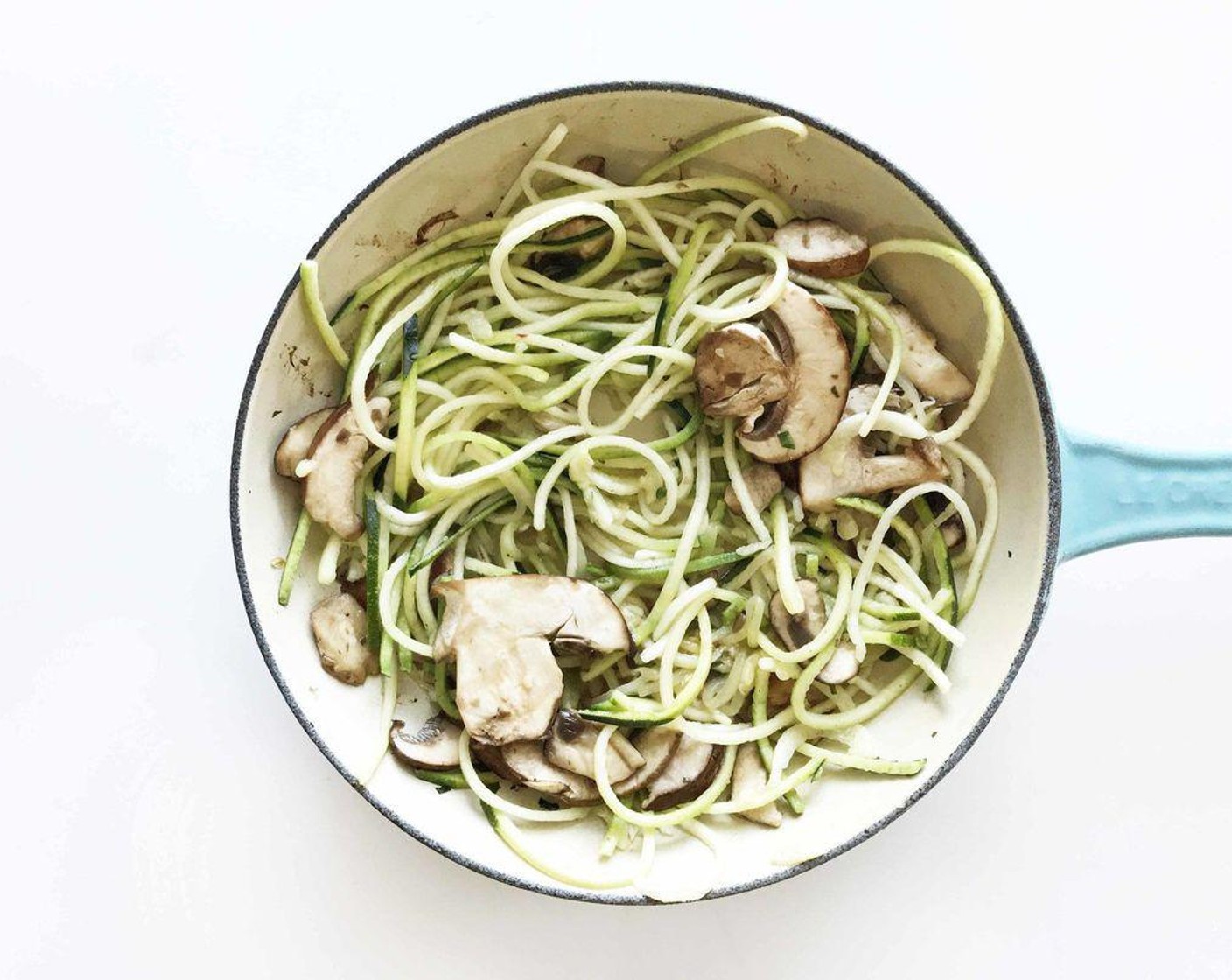 step 3 Place the spiralized zucchini and Mushroom (1 cup) into the skillet and cook over a medium heat for a minute or two - just enough to start to soften the zucchini.