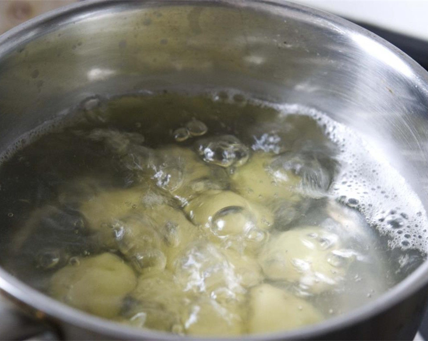 step 2 Wash and peel off the skin of the Potatoes (6) and boil them in a pot. Add Salt (1 tsp) to the water and cook for about 15 minutes.