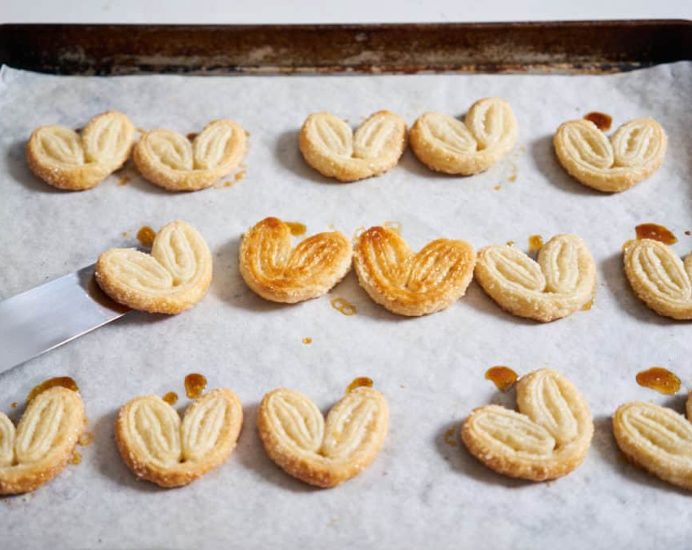 step 9 Once the palmiers are caramelized on the bottom, carefully flip each one over with an offset spatula and return to the oven for 5 more minutes.