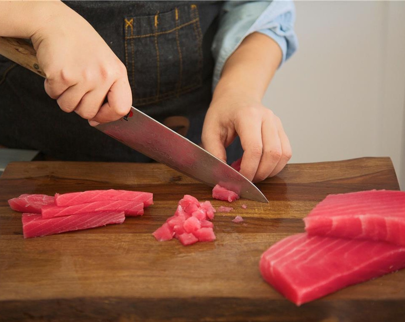 step 11 Cut the Ahi Tuna Steak (2) 1/2-inch cubes and place in the bowl with avocado mixture. Sprinkle Salt (1/2 tsp) over the fish and gently fold until well combined. Cover tightly with plastic wrap and place in the refrigerator to chill until plating.