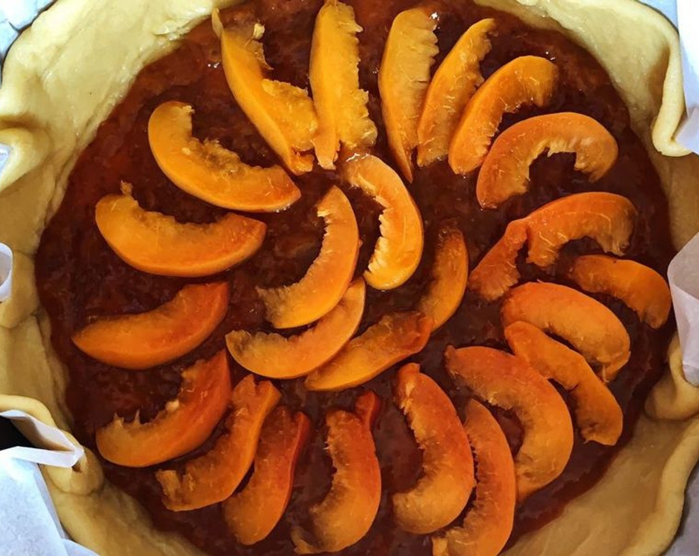 step 5 Lay the dough into a pie pan, cover the bottom with Apricot Jam (to taste) and Apricots (3).