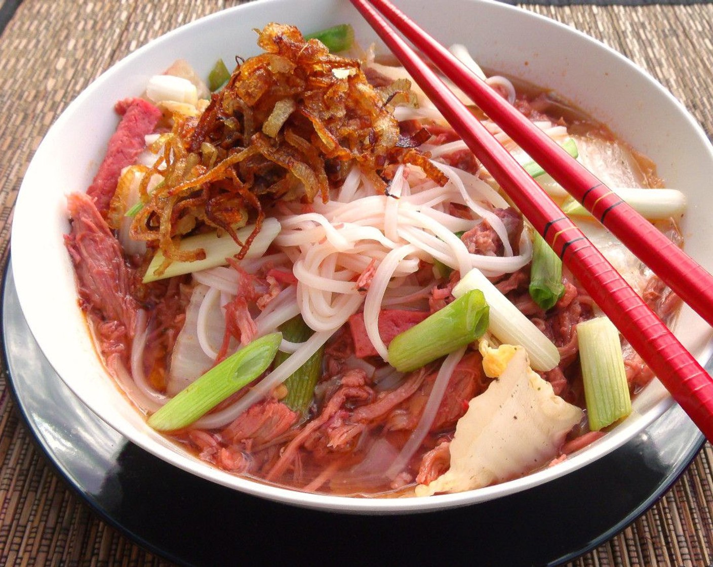 step 9 Add half the noodles to a soup bowl, add half the soup, top with half the onions. Serve and enjoy!