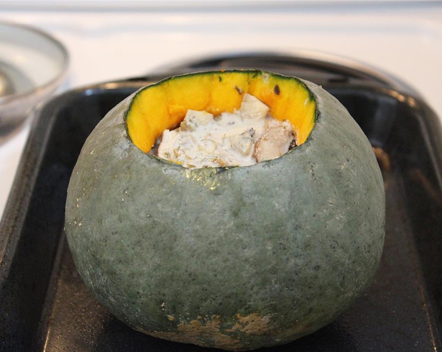step 7 Place the pumpkin on a baking pan or dish and roast for about 45 minutes to an hour – or until the skin of the pumpkin is easily pierced with a fork.
