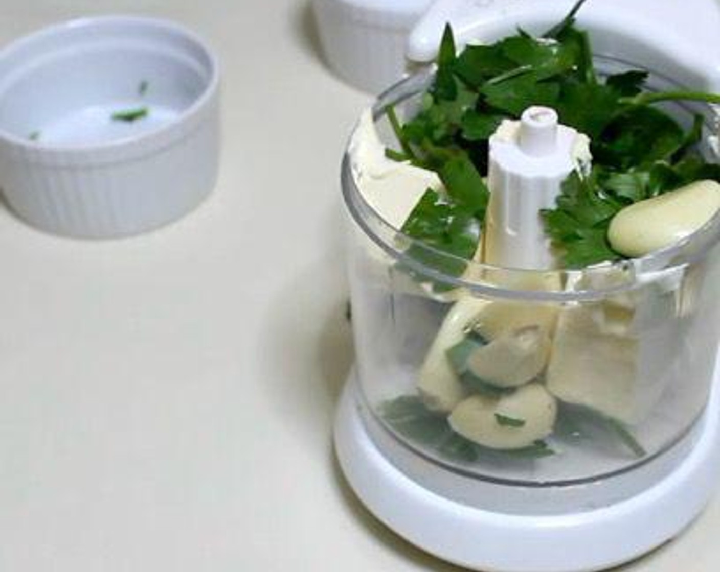 step 1 In a food processor, add Butter (1/2 cup), Fresh Parsley (4 Tbsp) and Garlic (5 cloves). Process until the mixture is smooth.