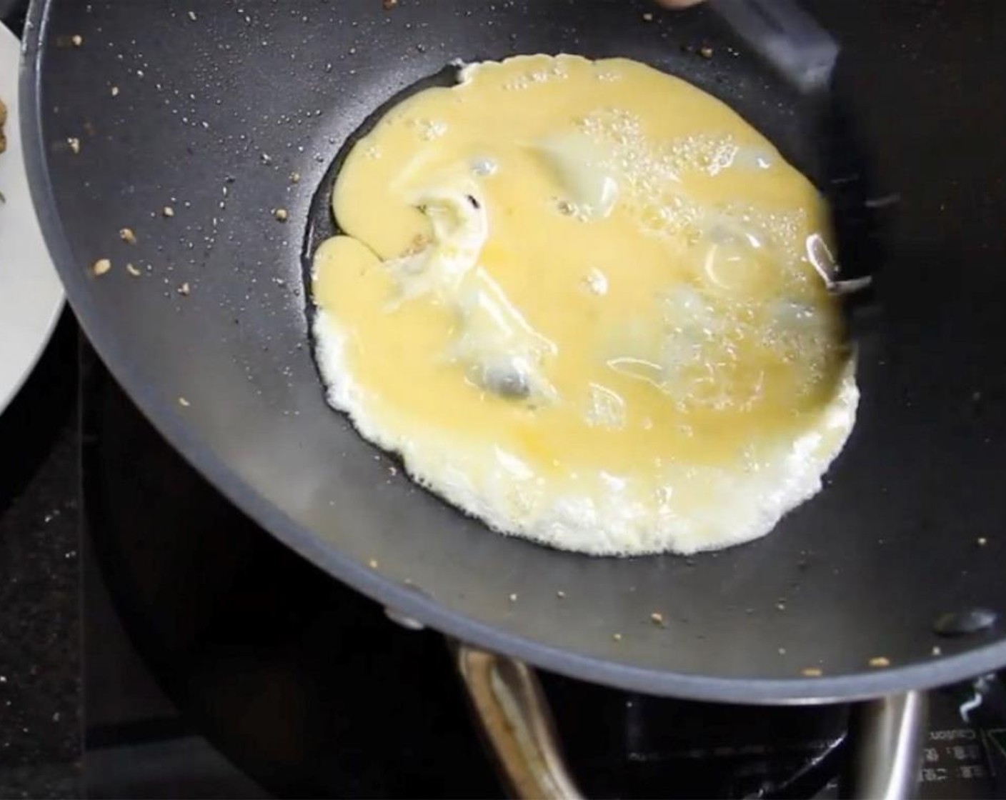 step 11 Beat an Egg (1). Heat up oil in your wok to medium-high heat and add in the egg. Let it cook until golden brown on each side.