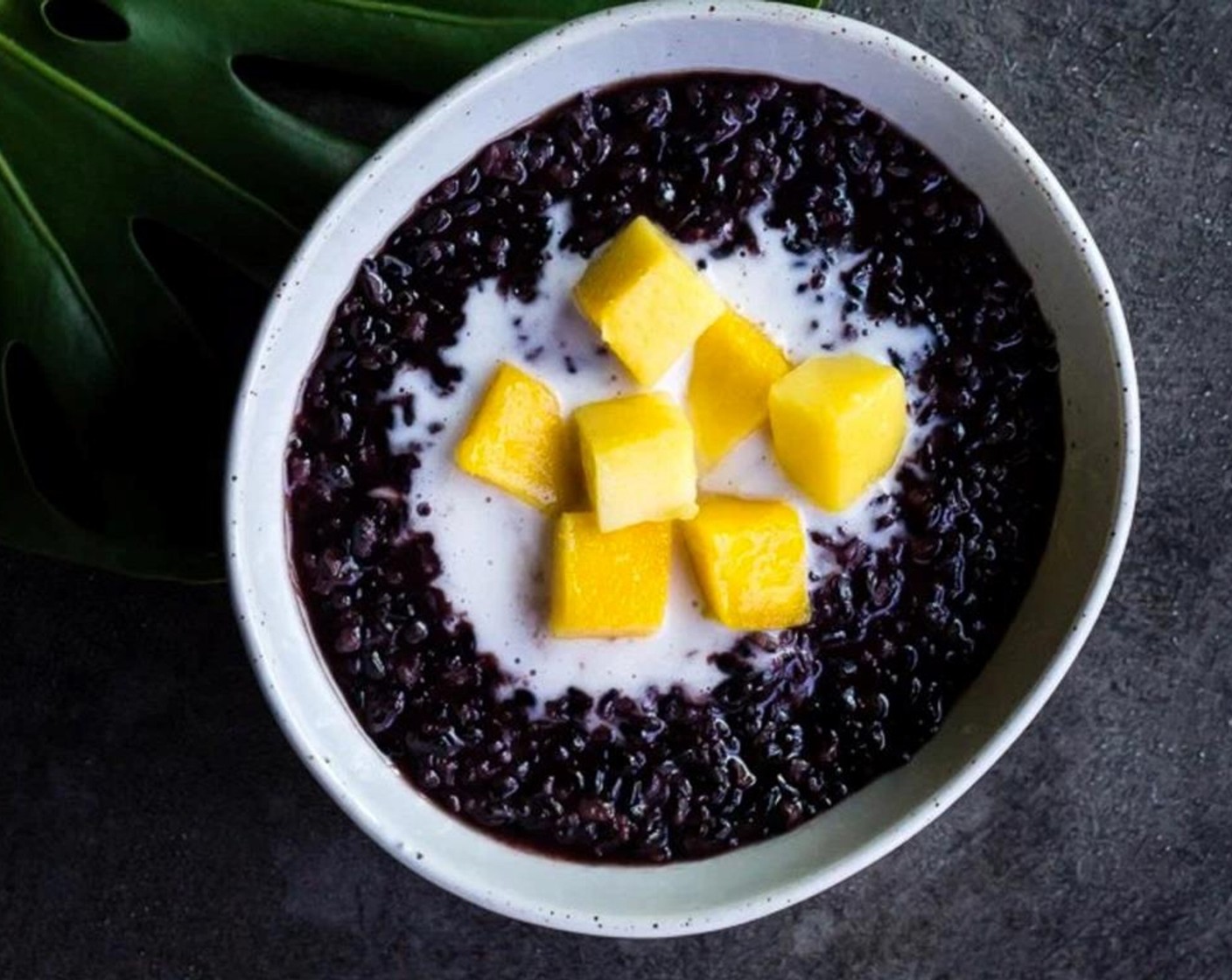 step 7 Divide the rice between 6 bowls, scoop a dollop of the coconut cream on to the top of the rice, add Mangoes (2) and finish each bowl off with a drizzle of pandan syrup.