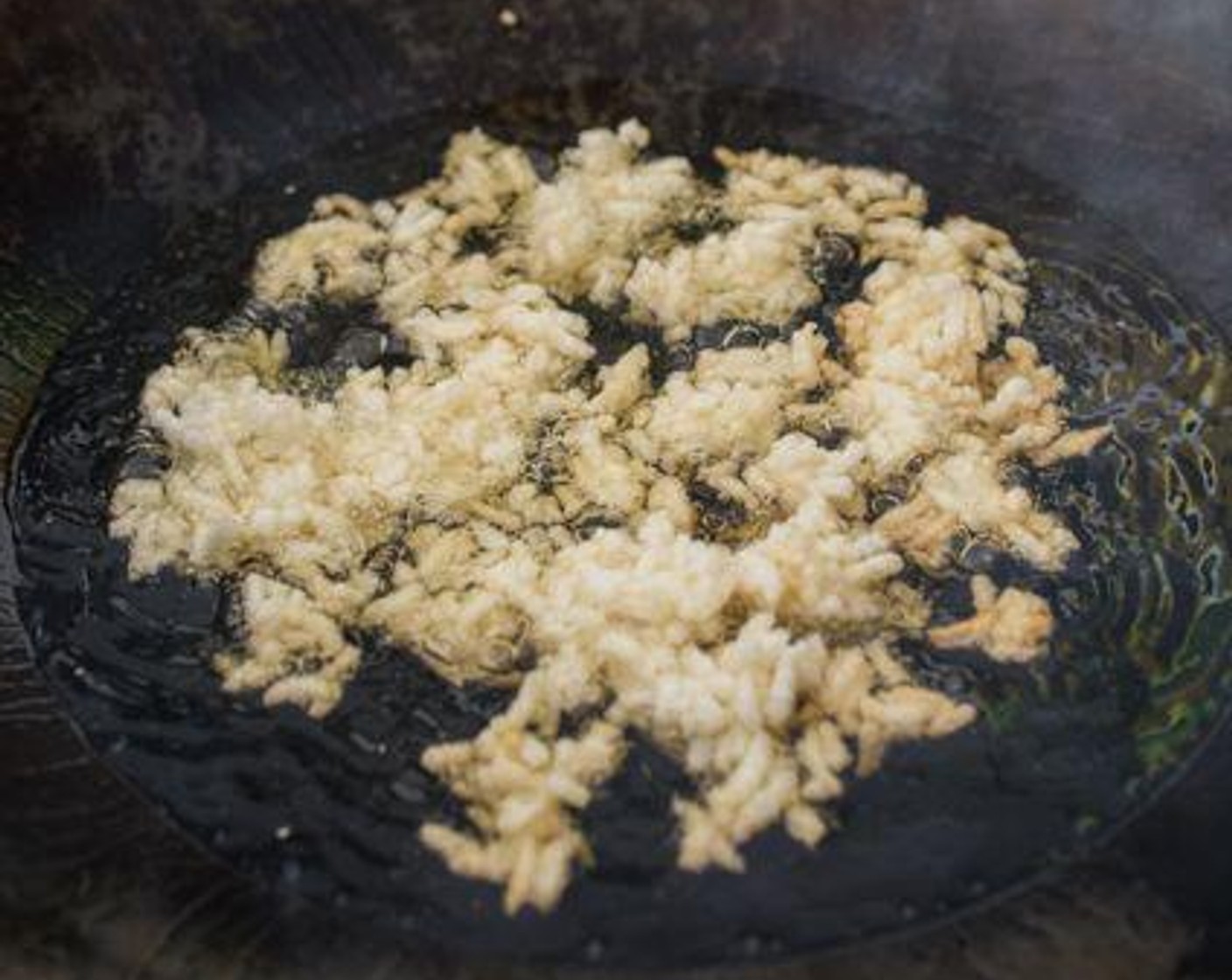 step 4 Just before serving, heat Cooking Oil (as needed) in a wok over medium-high heat. When the oil is hot, pour a small batch of rice into the wok. Deep-fry the rice in 2 - 3 batches until slightly golden brown. Use a stainless steel soup skimmer to scoop up the rice from the oil. Immediately pour the crispy rice into the soup for that sizzling effect. Serve and enjoy!