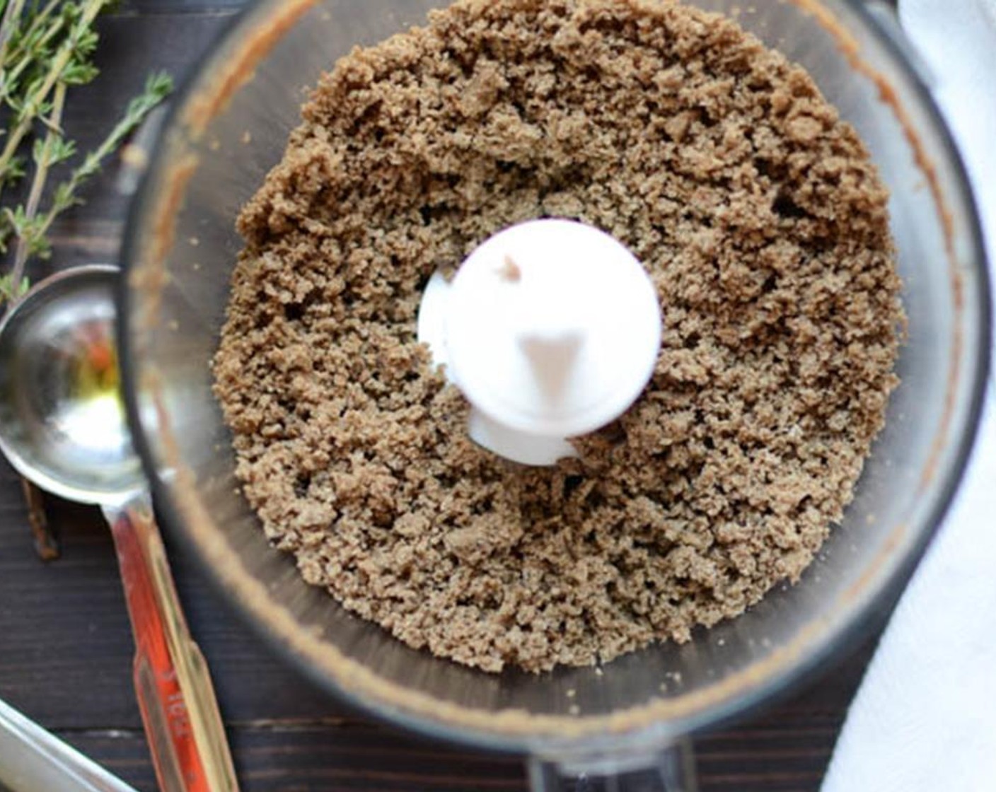 step 5 Meanwhile, place the Pumpernickel Bread (1 slice) in a mini prep food processor and pulse until you have fine breadcrumbs. Transfer breadcrumbs to a small bowl and add remaining tablespoon of Olive Oil (1 Tbsp). Toss to coat.