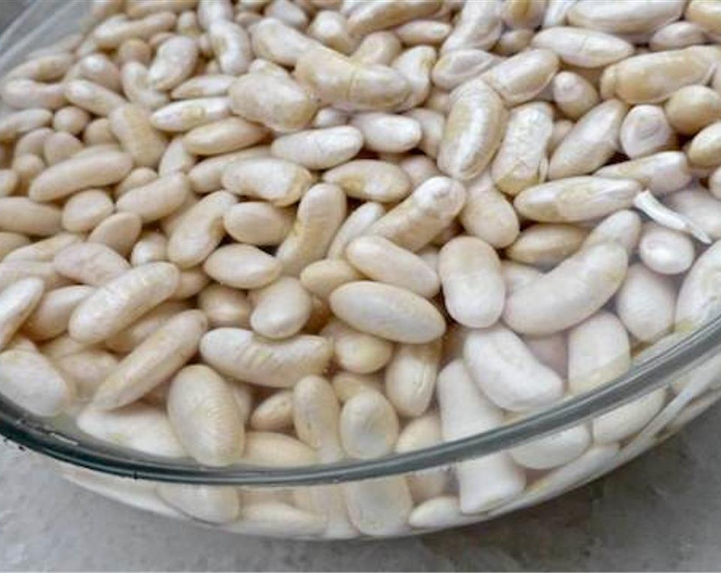 step 1 Make sure that the Dry White Beans (3 cups) have soaked in plenty of cold water before you start this recipe. Check the instructions on the package to know how long the dried white bean that you are using have to be soaked in advance.