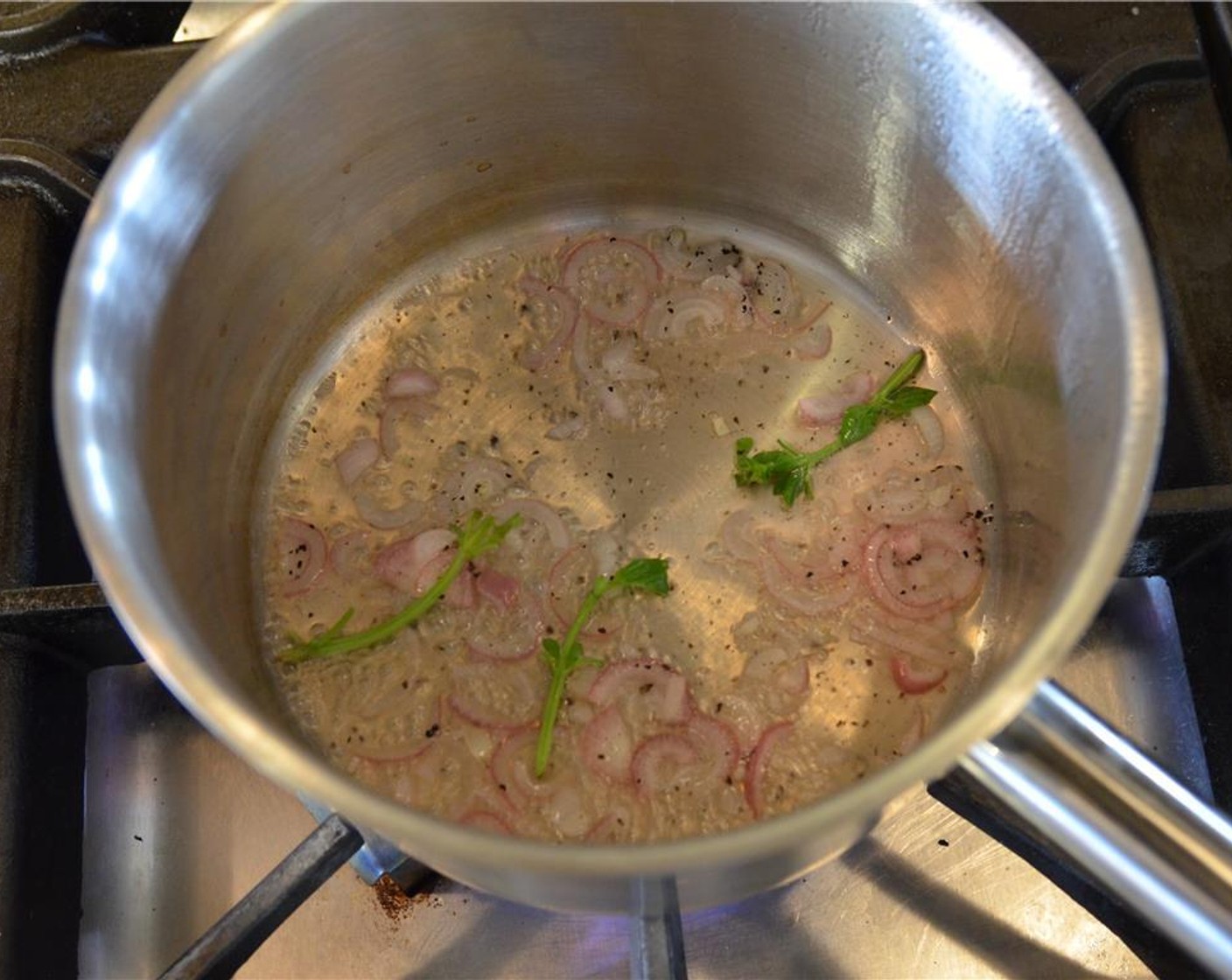 step 11 While potatoes are cooking, add the White Wine (1/2 cup) minced shallots to a separate saucepot and bring to a boil. Reduce heat slightly and simmer until the wine has almost all but evaporated.