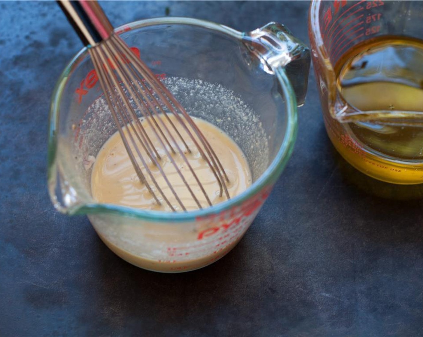 step 4 Add the juice from Lemons (1 1/4) to the Shallot (1 Tbsp), Garlic (1 clove), Dijon Mustard (2 Tbsp), Sea Salt (1/4 tsp), and Ground Black Pepper (to taste). Whisk to combine. Slowly whisk the remaining olive oil.