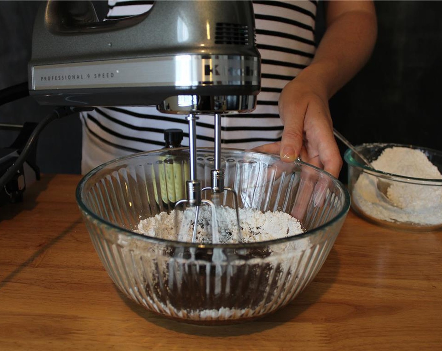 step 10 Start by adding 1/3 of the Powdered Confectioners Sugar (1 cup) into the bowl and beat with a hand mixer.
