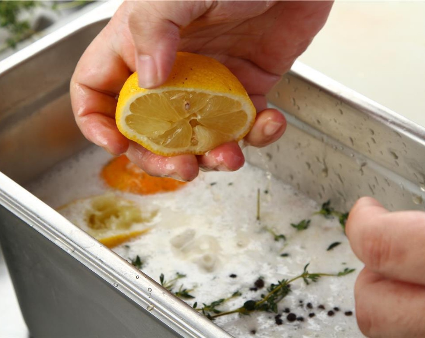 step 3 Cut the Orange (1) and Lemon (1) in half, and squeeze each half into the brine and throw the pieces in as well.