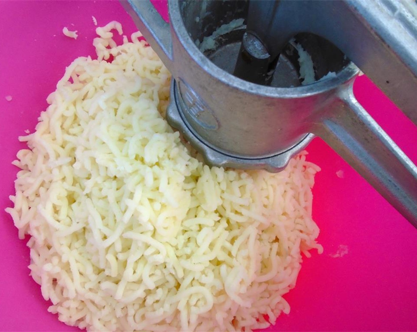 step 7 Once the yukon potato are finished, drain them and squeeze them through a potato ricer. If you do not have a potato rice, you can use a masher.