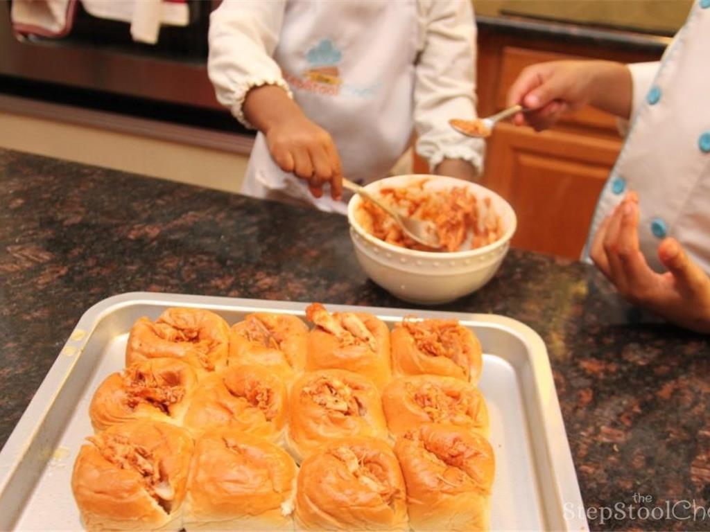 Step 4 of Pull Apart BBQ Chicken Sliders Recipe: Fill each pull apart dinner roll with the barbecue rotisserie chicken mixture.