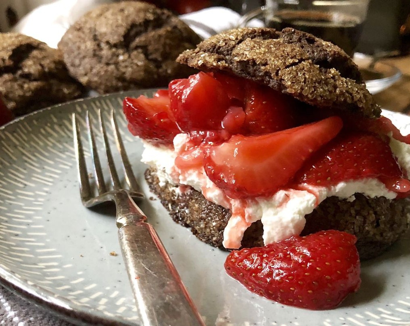 step 10 Use a serrated knife to gently slice each shortcake. Top the bottoms with whipped cream, spoon macerated strawberries over top, and perch shortcake hats on top. Serve immediately.