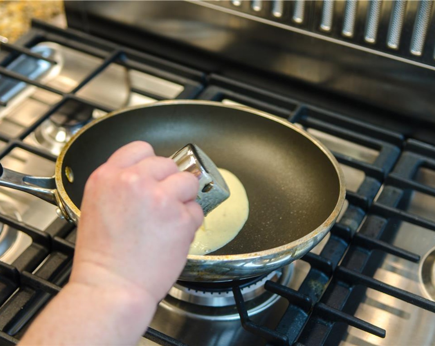 step 6 Using ¼ cup of batter per crepe, pour one serving into the hot pan and immediately begin to tilt the pan and swirl the batter to evenly coat the base.