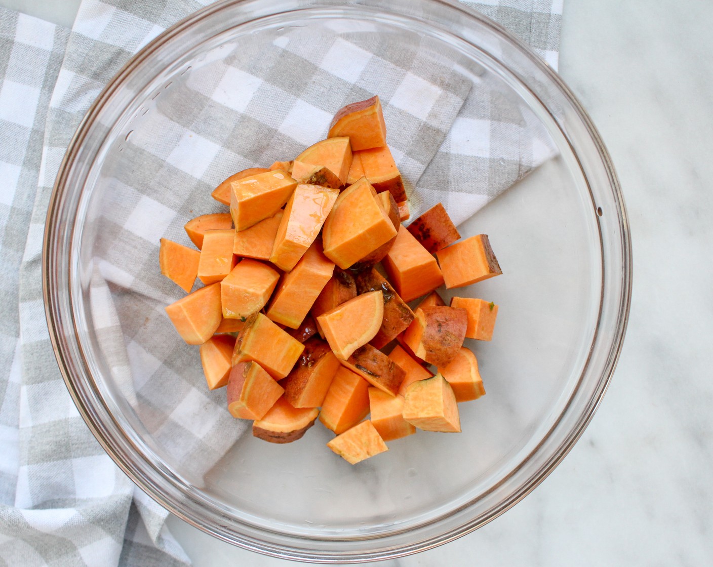 step 2 In a large bowl toss Sweet Potatoes (4) with Olive Oil (1 tsp), Dried Oregano (1/2 tsp), Salt (to taste), and Ground Black Pepper (to taste). Place on a large parchment paper-lined baking sheet. Bake for 20 minutes until sweet potatoes begin to soften.