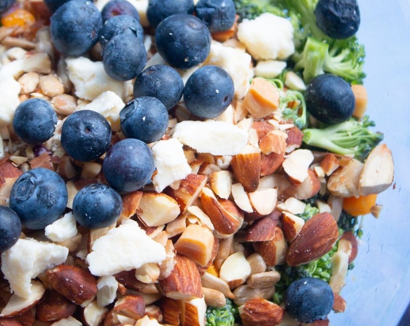 step 1 In a large bowl combine Broccoli Florets (2 1/2 cups), Red Onion (1/4 cup), Sharp Cheddar Cheese (1/4 cup), Roasted Sunflower Seeds (1/4 cup), Roasted Almonds (1/4 cup), Crumbled Feta Cheese (1/4 cup) and Fresh Blueberry (1/4 cup). Toss well.