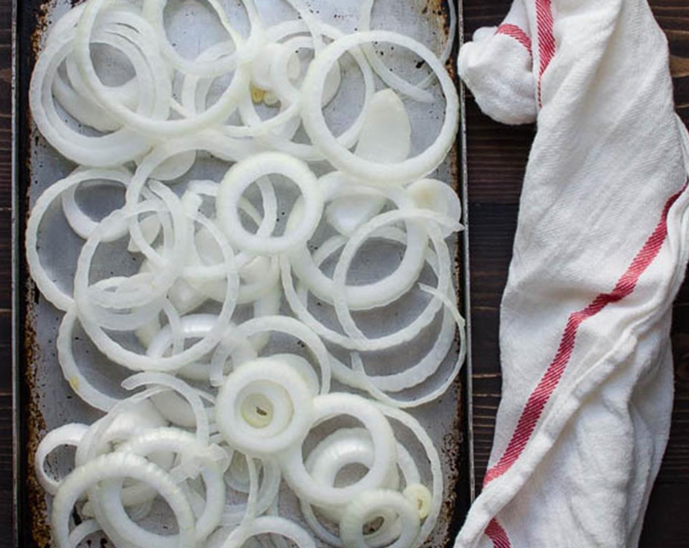 step 7 Slice the Vidalia Onion (1) crosswise in about 1/4-1/2 inch rings and arrange them on a rimmed baking sheet. Remove the chicken thighs from the marinade and pat them dry with a paper towel. Arrange the chicken on top of the onions.