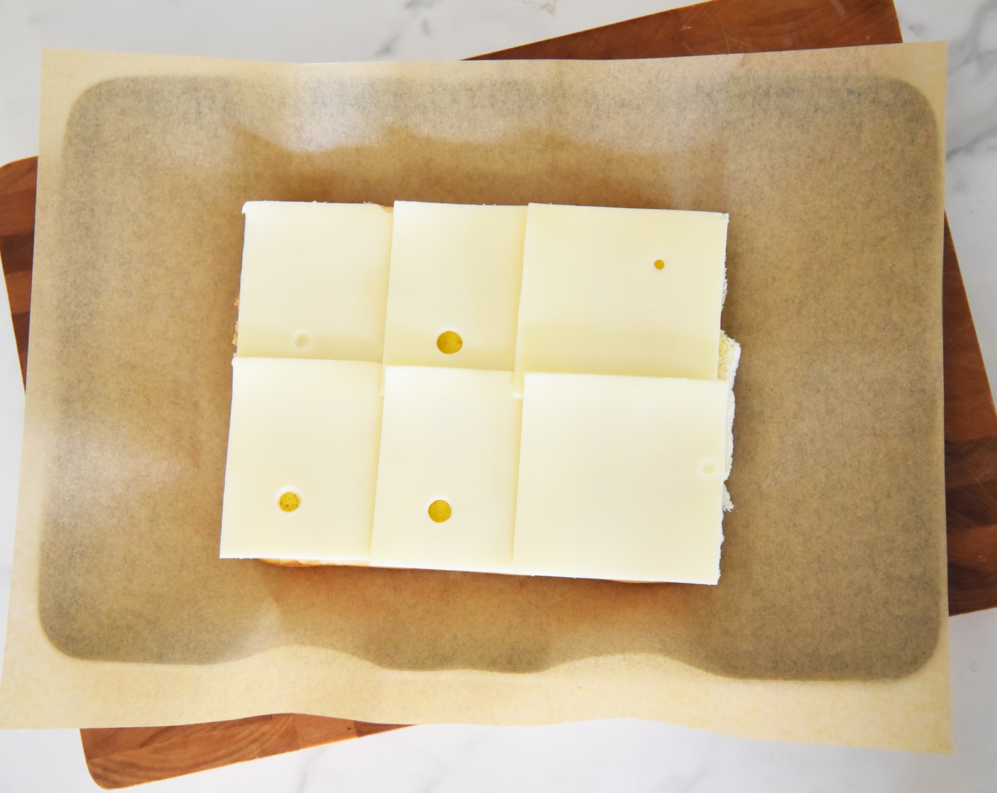 step 4 Lay the Swiss Cheese (6 slices) over the mustard.