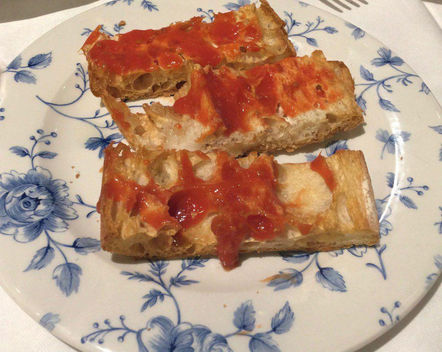 step 2 Remove the toasted bread from the heat and immediately rub Garlic (8 cloves) onto the warm bread. Next, rub Vine-Ripened Tomatoes (4) vigorously against the bread as well.