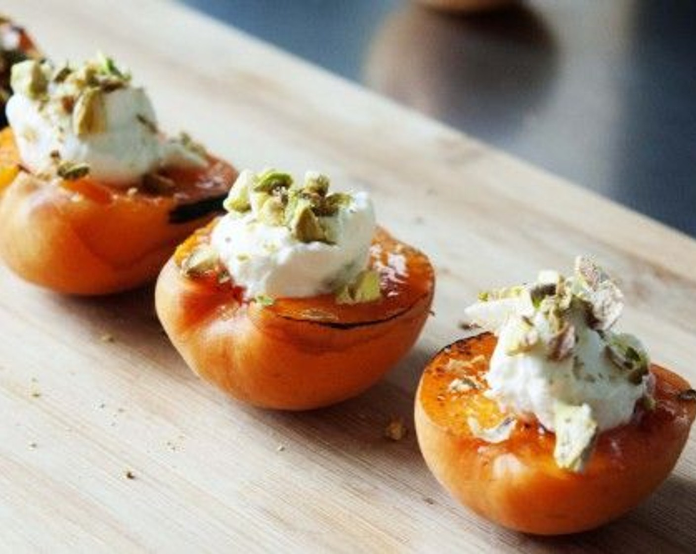 step 3 Remove from the oven, place one teaspoon of Ricotta Cheese (1/3 cup) in the center of each apricot. Sprinkle with Pistachios (1/4 cup) and serve.