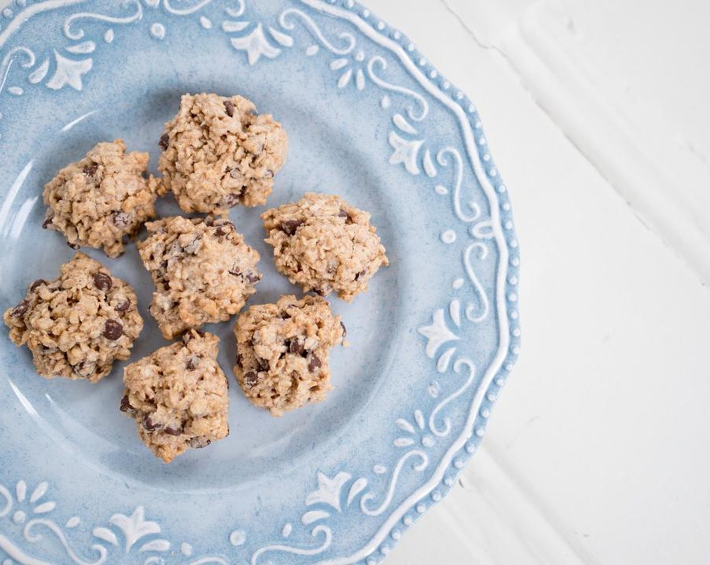 step 3 Grease a baking sheet or line with parchment paper. Drop spoonfuls onto baking sheet. Bake for ten to twelve minutes or until edges are golden brown. Let cool slightly then transfer to a cooling rack.