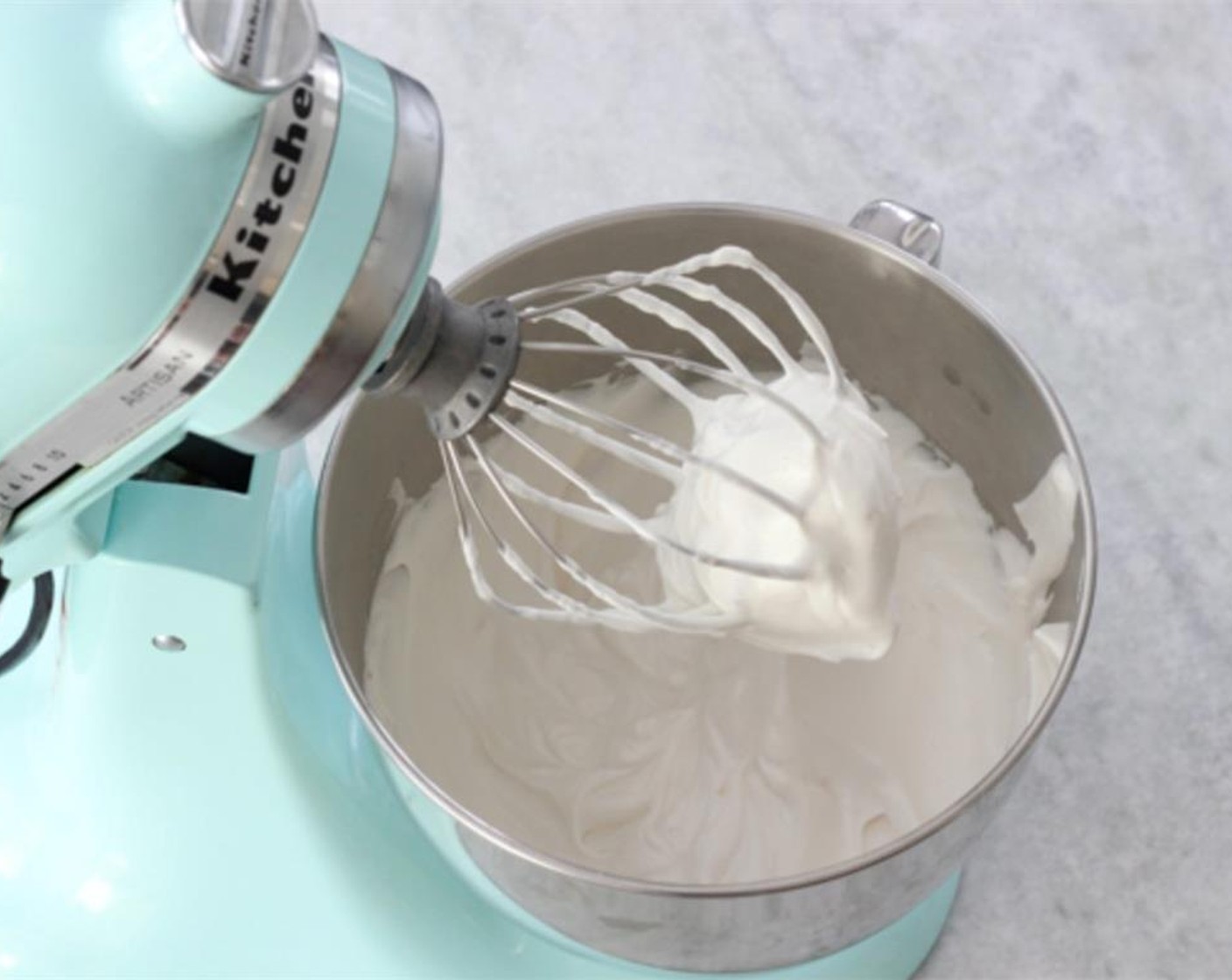 step 18 In the large bowl of a standing mixer, using a whisk attachment, whisk the whites of the Eggs (7) until frothy. Gradually pour in the remaining Granulated Sugar (1/2 cup) then add the juice from Lemon (1) and Vanilla Extract (1 tsp).