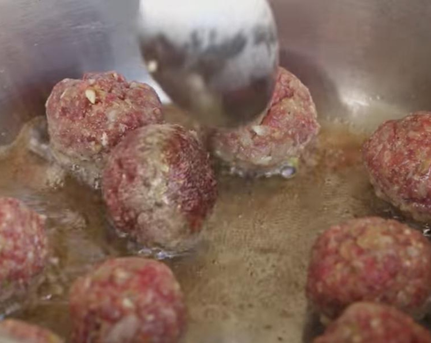 step 4 Add Cooking Oil (1 Tbsp) to a pan on medium-high heat. Once heated, add meatballs to the pan in batches. After a few minutes, rotate meatballs to cook all sides evenly.