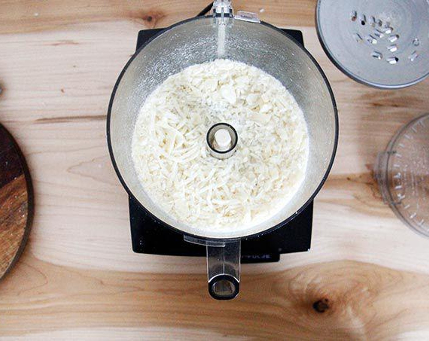 step 4 To grate the cheese: Wipe out the processor, switch to the grating attachment, and pass hunks of Parmesan Cheese (to taste) through the food chute.