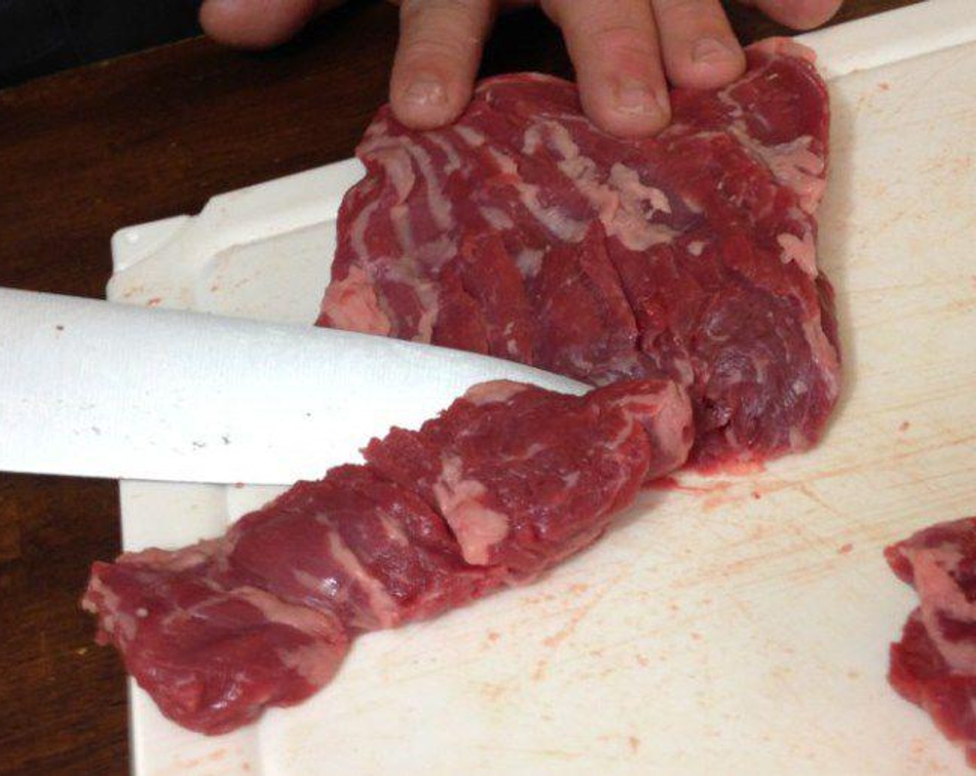 step 1 The day before cut the Skirt Steak (1 lb) in half with the grain. Hold your knife at a slight angle and slice each piece of steak into strips. The angle creates wider strips.
