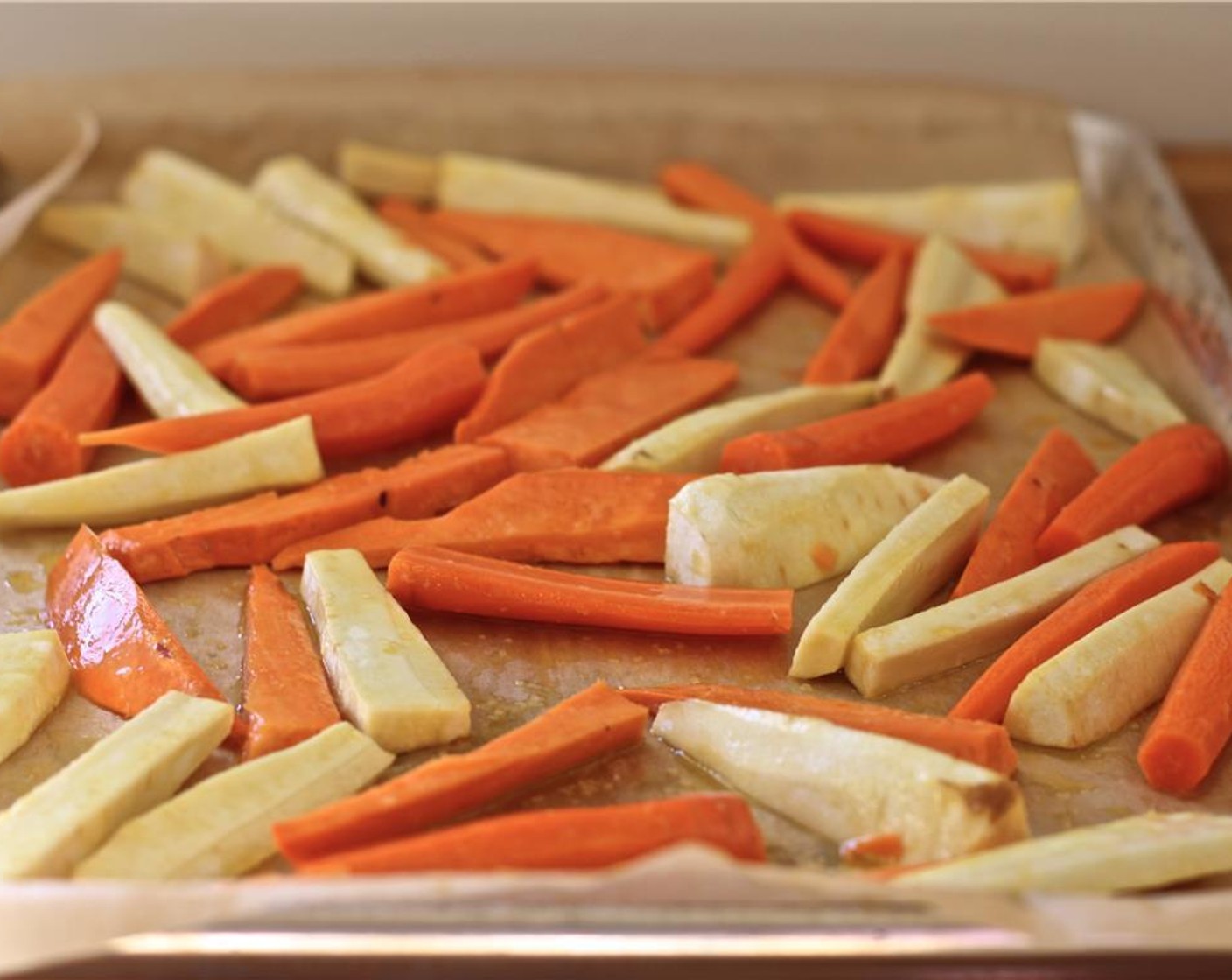 step 5 In large bowl, toss together carrots, parsnips, sweet potato and Olive Oil (2 Tbsp); spread in even layer on parchment­ paper–lined baking sheet. Bake, turning once, for 30 to 35 minutes or until just tender and golden brown on the edges.