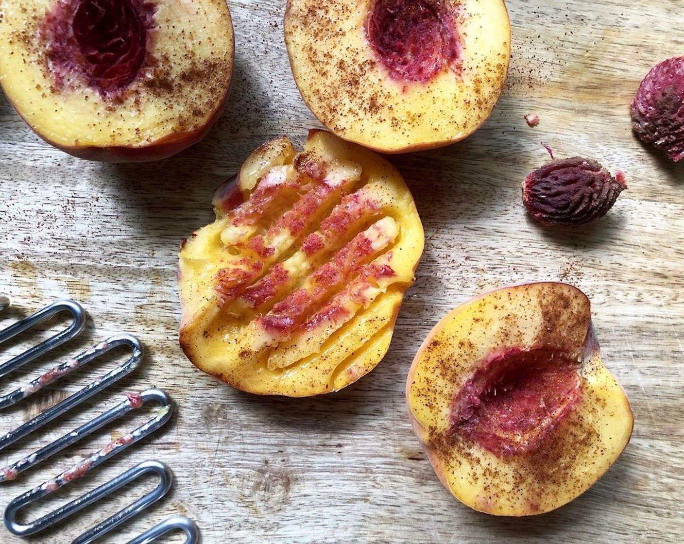 step 4 If desired, sprinkle cut sides of Peaches (2) halves with the Ancho Chili Powder (1/2 tsp). Using a potato masher or the flat side of a meat mallet, gently smash peach halves to 1/2-inch thickness.