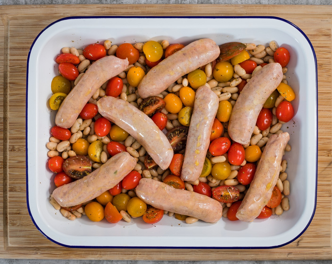 step 3 Nestle the Pork Sausages (8) into the pan, then drizzle them with Olive Oil (2 Tbsp). Cook for 25 minutes, turning the sausages halfway through cooking. At the end of the cooking time, the sausages should be golden brown and the tomatoes will have collapsed.