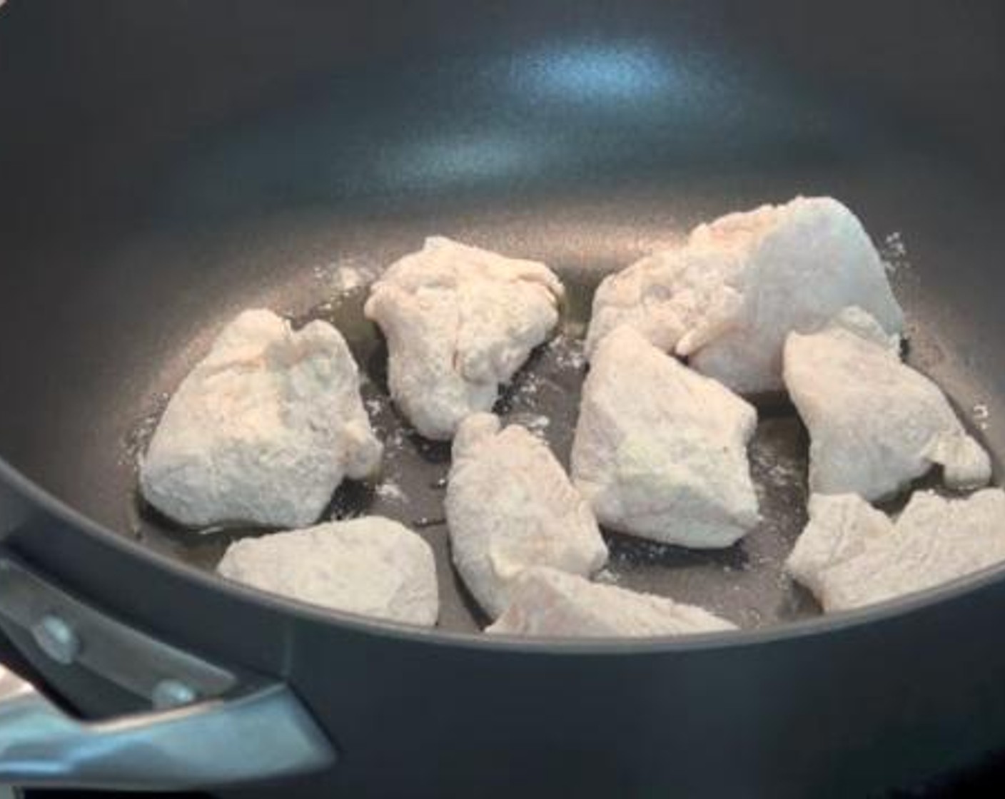 step 2 In a large greased frying pan, cook the chicken fillets for about 2 minutes on each side.