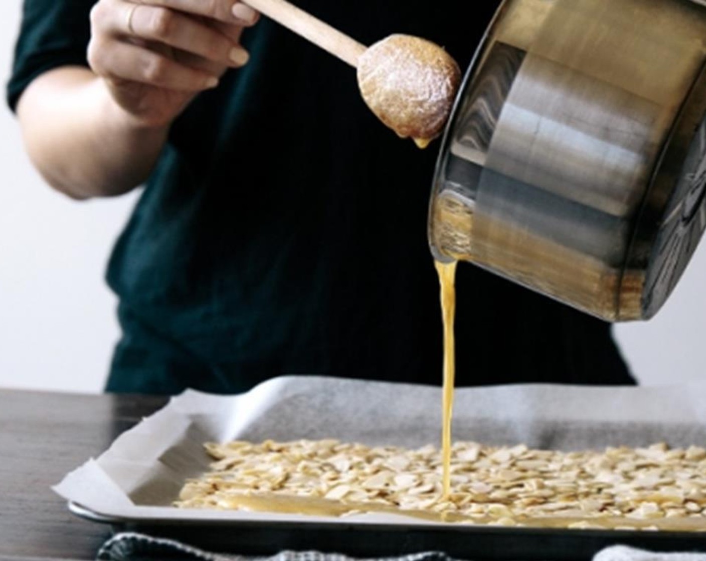 step 2 Pour the hot honey over the almonds, ensure all the almonds are coated with the honey, then set aside to cool.