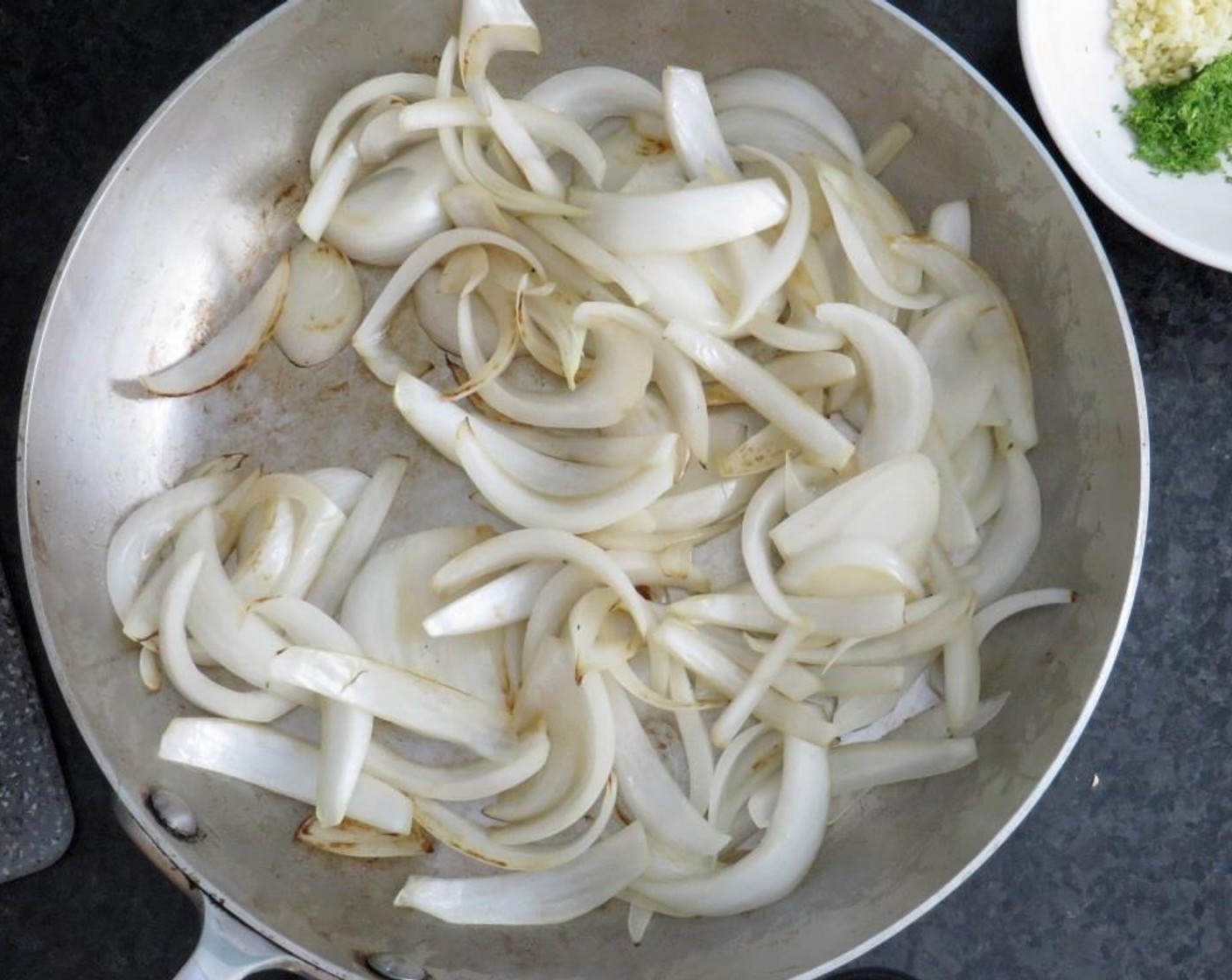 step 5 Add Olive Oil (1 Tbsp) to a medium skillet. Saute sliced onion over medium high heat until crisp tender. Transfer to prepared baking sheet.