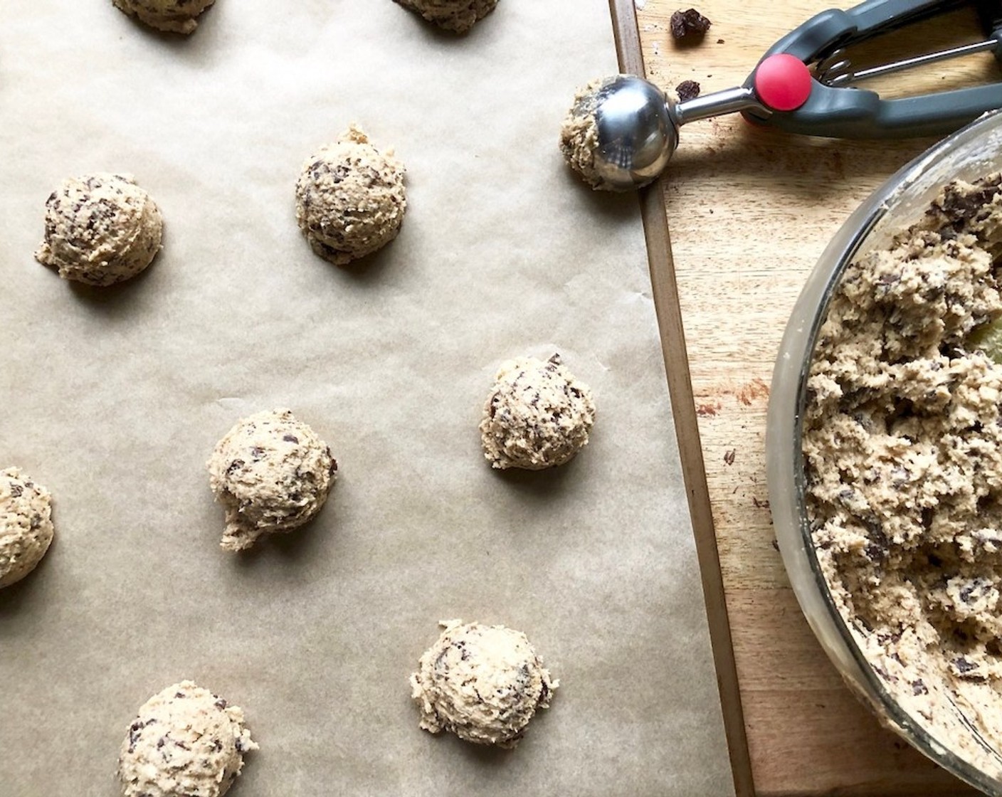 step 7 With a 1 1/2 Tbsp ice cream scoop (or two spoons), scoop round balls of dough onto the prepared sheet pans. Sprinkle lightly with Sea Salt Flakes (to taste).